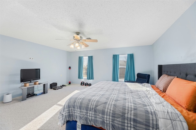 bedroom featuring ceiling fan, carpet, and a textured ceiling