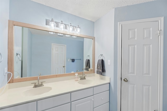 bathroom with a textured ceiling and vanity