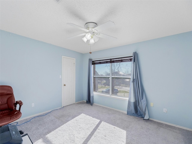 carpeted bedroom with a textured ceiling and ceiling fan