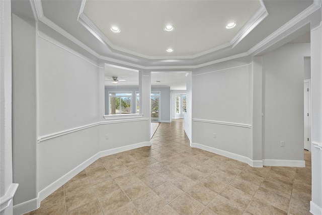 unfurnished room with a raised ceiling and ornamental molding