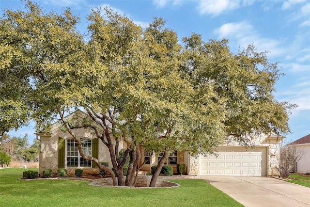 view of property hidden behind natural elements featuring a garage and a front yard