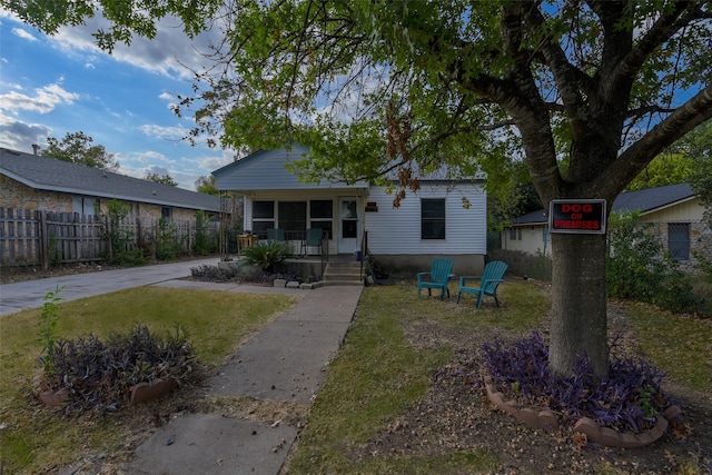 view of front of house with a porch and a front lawn