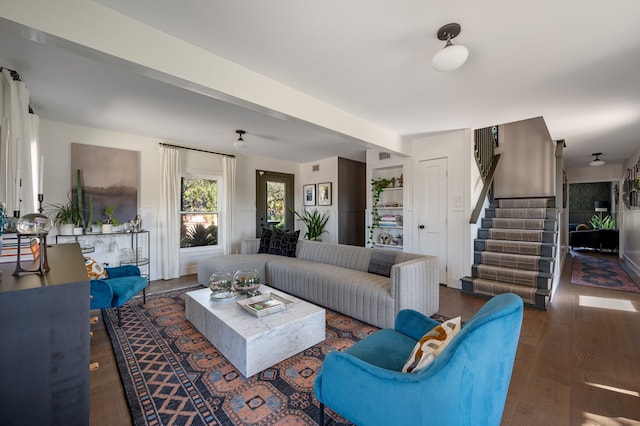 living room with dark wood-type flooring and built in features