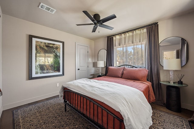 bedroom with dark hardwood / wood-style floors and ceiling fan