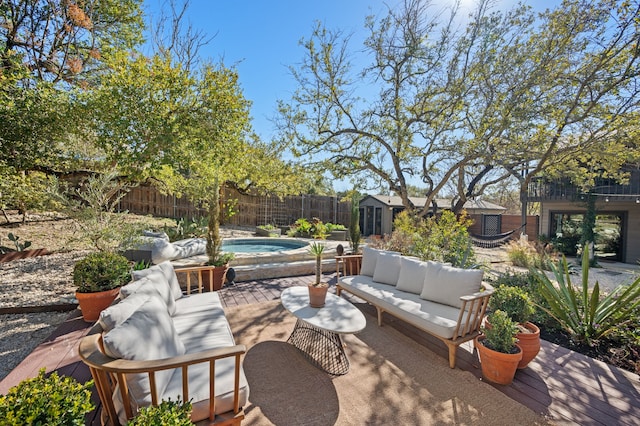 view of patio with a fenced in pool, a storage shed, and an outdoor living space