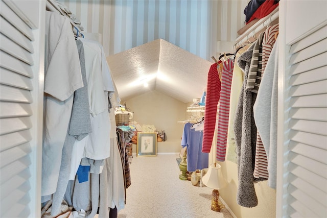 spacious closet featuring carpet floors and lofted ceiling