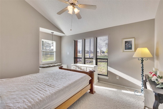 carpeted bedroom featuring multiple windows, vaulted ceiling, and ceiling fan