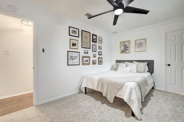 bedroom with light colored carpet, ceiling fan, and ornamental molding