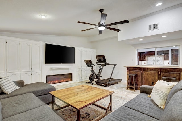 living room with ceiling fan and vaulted ceiling