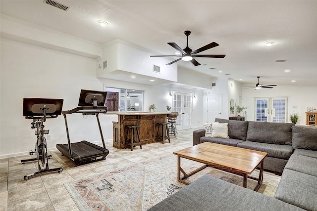 living room with crown molding, a textured ceiling, vaulted ceiling, and ceiling fan