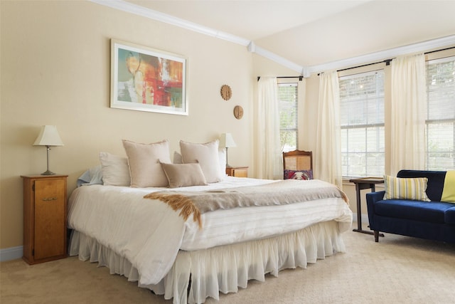 carpeted bedroom featuring multiple windows and ornamental molding