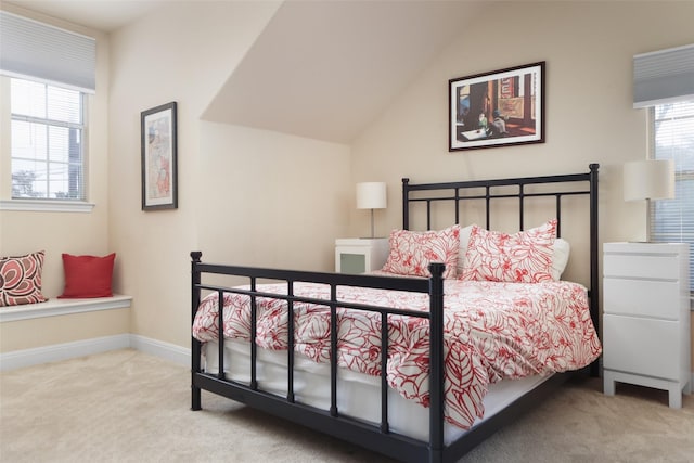 bedroom with lofted ceiling and carpet flooring