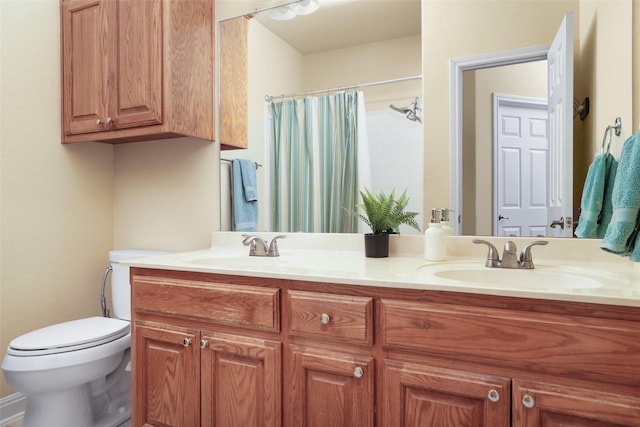 bathroom featuring toilet and vanity