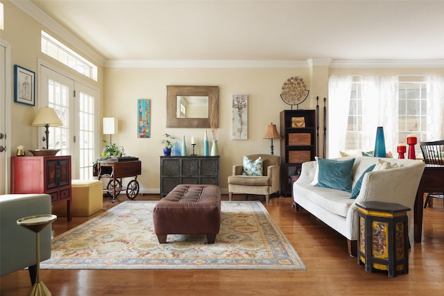 living area with dark wood-type flooring and ornamental molding