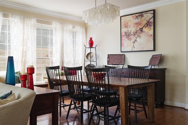 dining area featuring an inviting chandelier, crown molding, and dark hardwood / wood-style floors