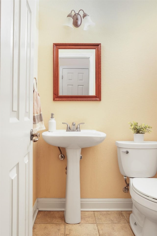 bathroom with tile patterned flooring and toilet