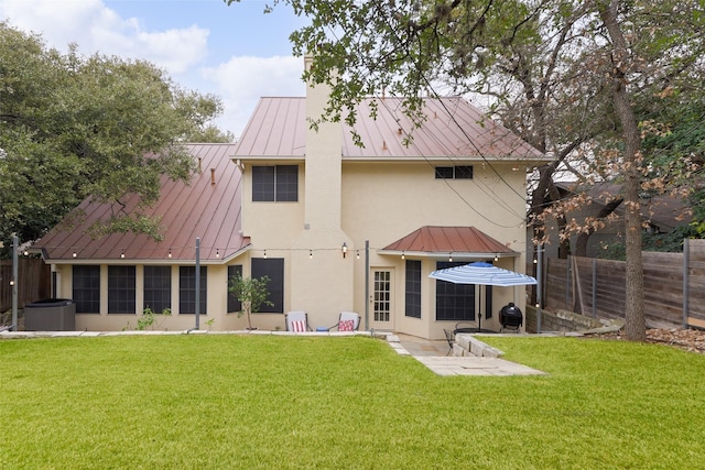 back of house with a lawn