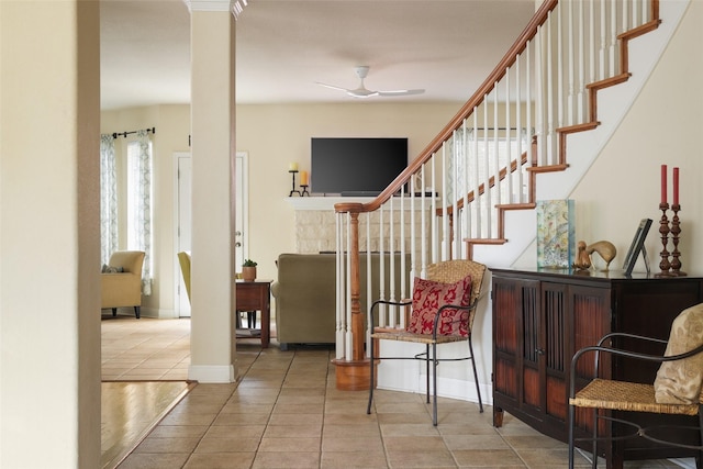 interior space featuring ceiling fan, tile patterned flooring, and ornate columns