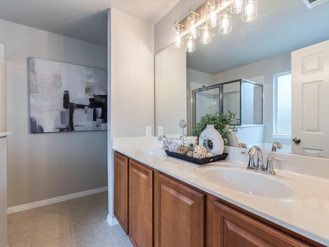 bathroom with walk in shower, vanity, and tile patterned flooring