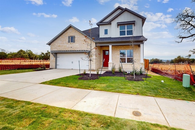 craftsman-style home featuring a garage and a front lawn