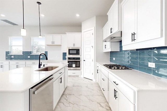 kitchen with sink, white cabinetry, an island with sink, pendant lighting, and stainless steel appliances