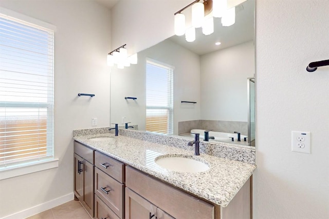 bathroom with tile patterned flooring, vanity, and a washtub