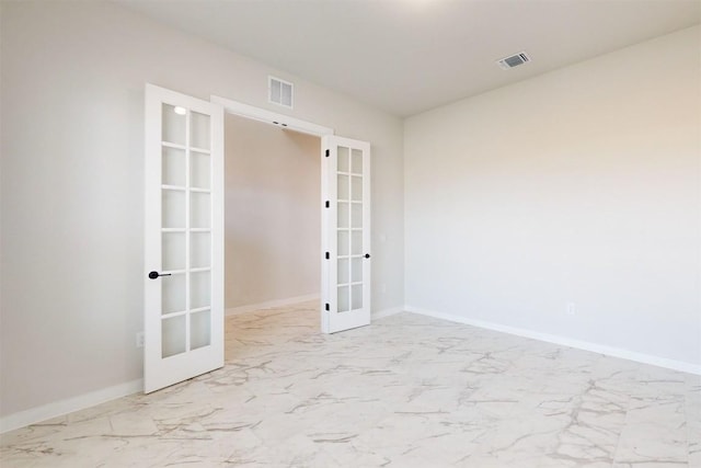 unfurnished room featuring french doors