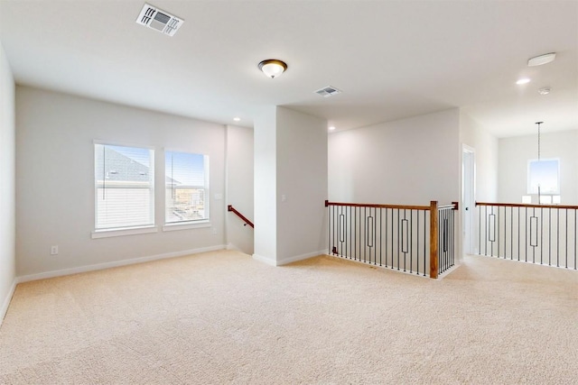 unfurnished room featuring light colored carpet