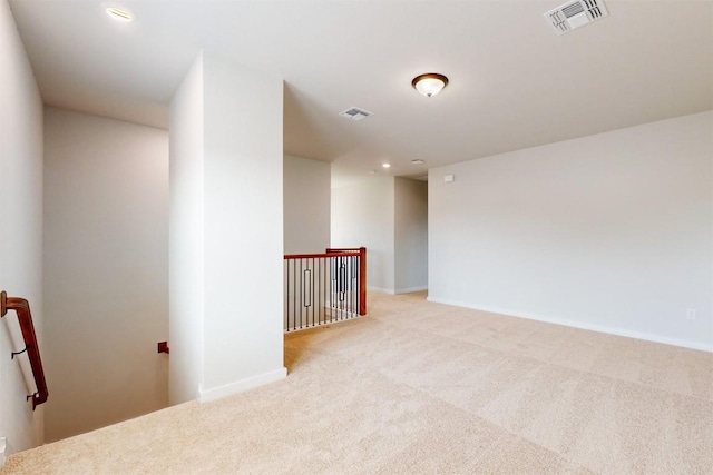 unfurnished room with light colored carpet