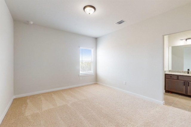 empty room with sink and light colored carpet