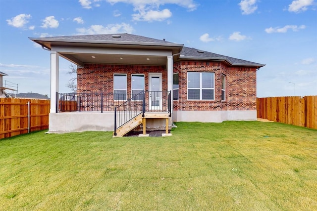 rear view of house featuring a lawn