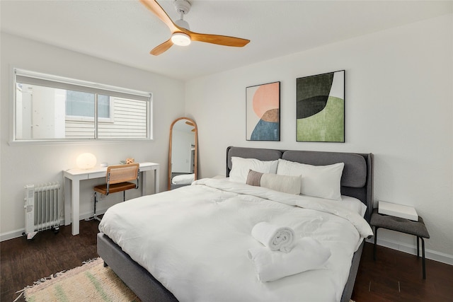 bedroom with ceiling fan, radiator heating unit, and dark hardwood / wood-style flooring