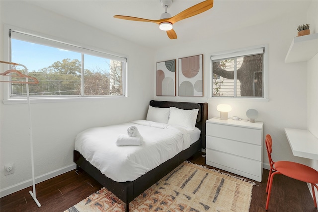 bedroom with ceiling fan and dark hardwood / wood-style flooring