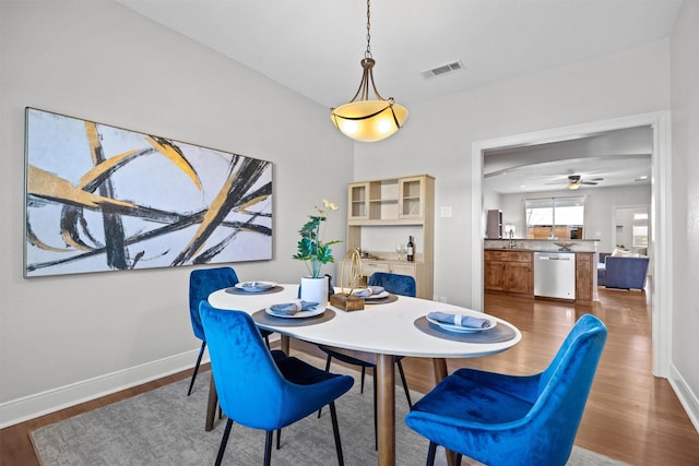 dining room featuring sink and hardwood / wood-style flooring