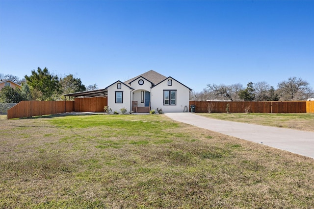 view of front of home with a front lawn and a carport