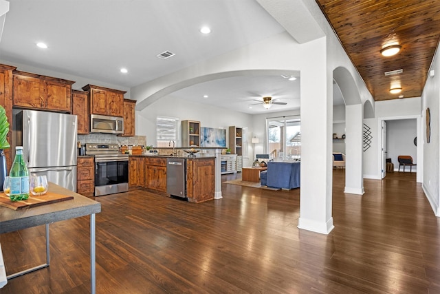 kitchen featuring stainless steel appliances, wooden ceiling, tasteful backsplash, kitchen peninsula, and ceiling fan