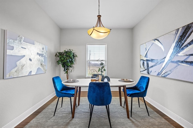 dining space featuring dark wood-type flooring