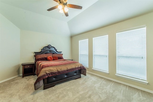 carpeted bedroom featuring lofted ceiling and ceiling fan