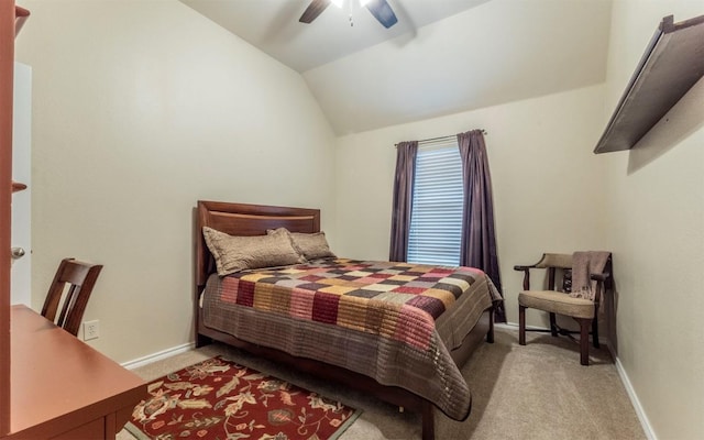 bedroom with light carpet, lofted ceiling, a ceiling fan, and baseboards