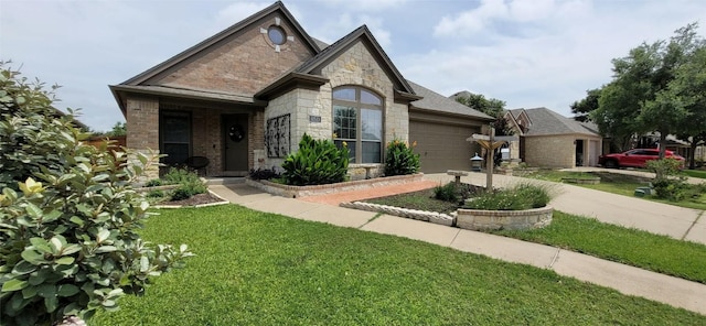 11513 Glen Knoll Dr, Manor, TX 78653 - french country style house featuring stone siding, a garage, a front yard, and driveway