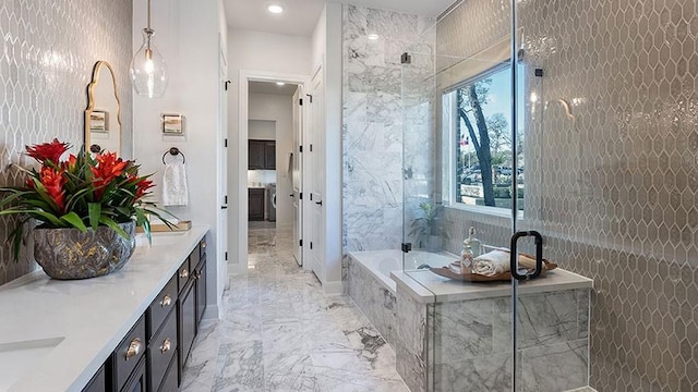 bathroom with tile walls, vanity, and plus walk in shower