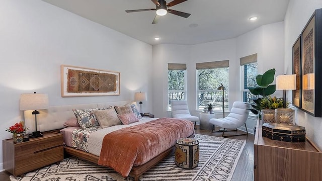 bedroom with ceiling fan and wood-type flooring