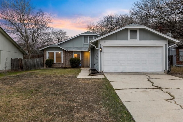 view of front of property featuring a garage and a yard