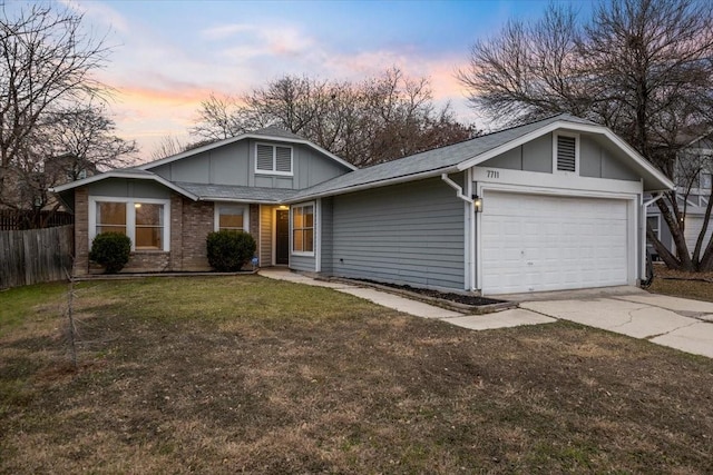 view of front of home featuring a garage and a yard