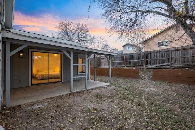 yard at dusk featuring a patio