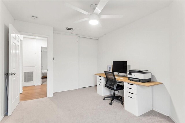 office with ceiling fan and light carpet