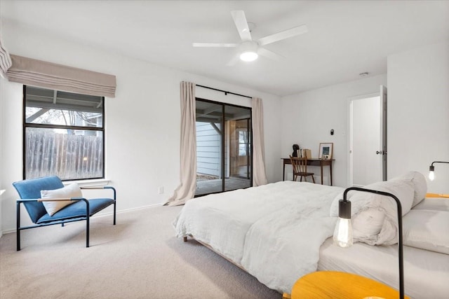 carpeted bedroom with ceiling fan and access to exterior