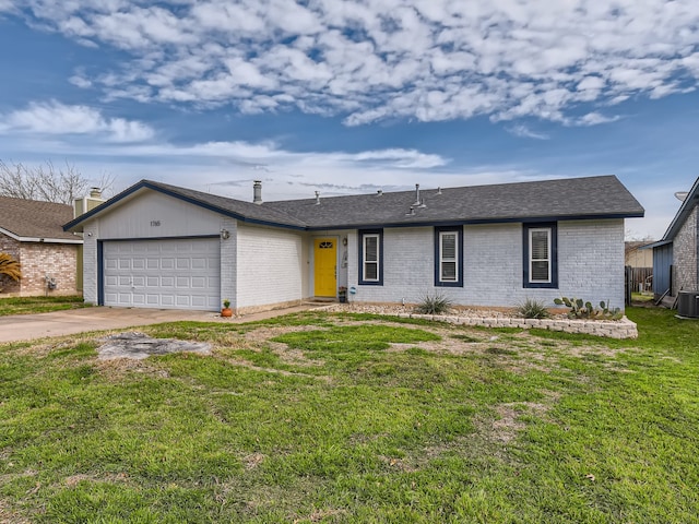 ranch-style house featuring central air condition unit, a front yard, and a garage