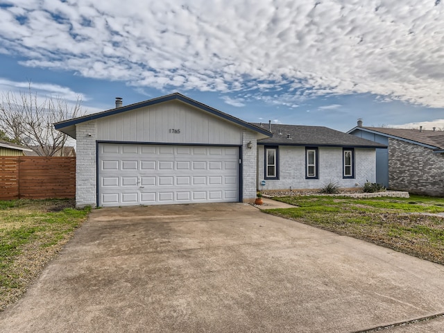 ranch-style house with a garage and a front lawn