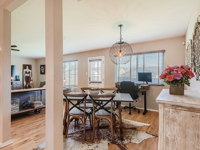 dining space with light wood-type flooring and plenty of natural light